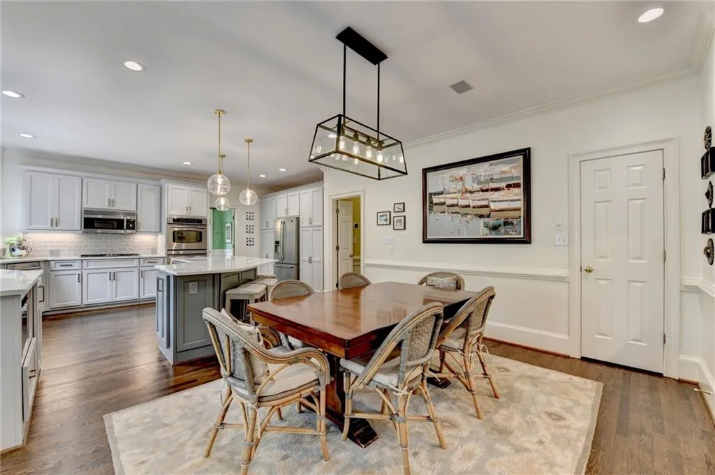 Dining space featuring recessed lighting, dark wood finished floors, and ornamental molding