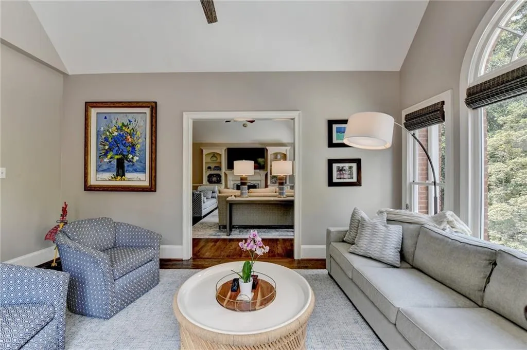 Living room with vaulted ceiling and wood finished floors