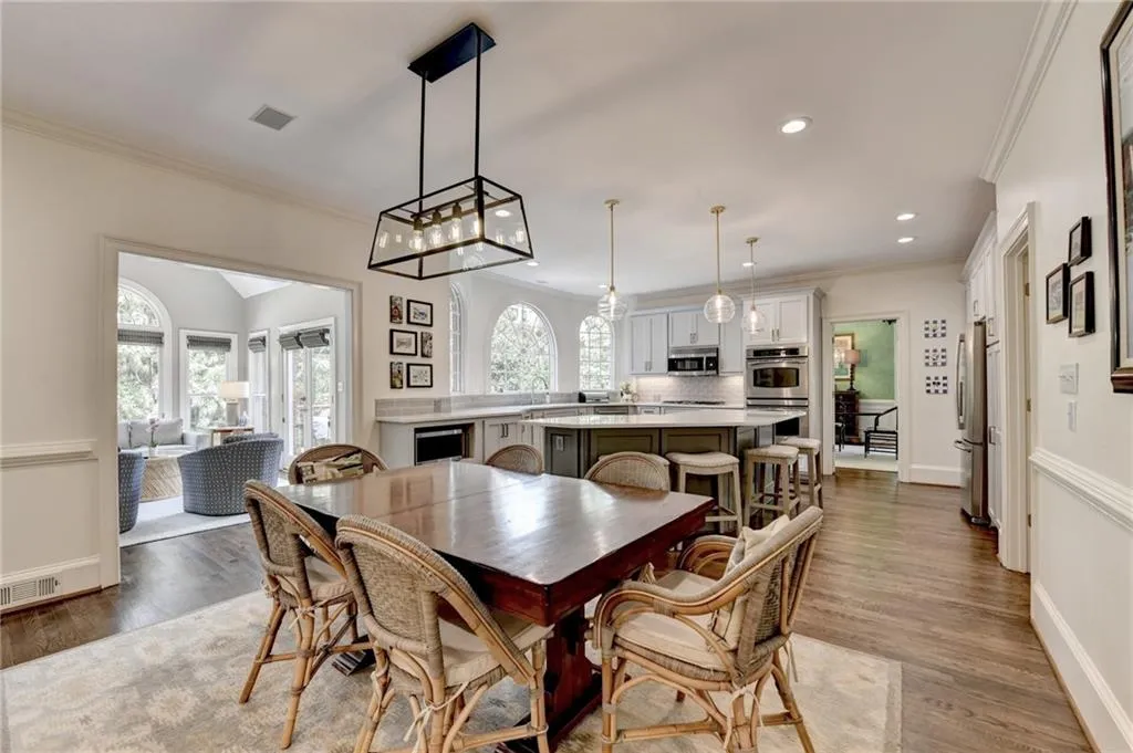 Dining space featuring ornamental molding, light wood-type flooring, and recessed lighting
