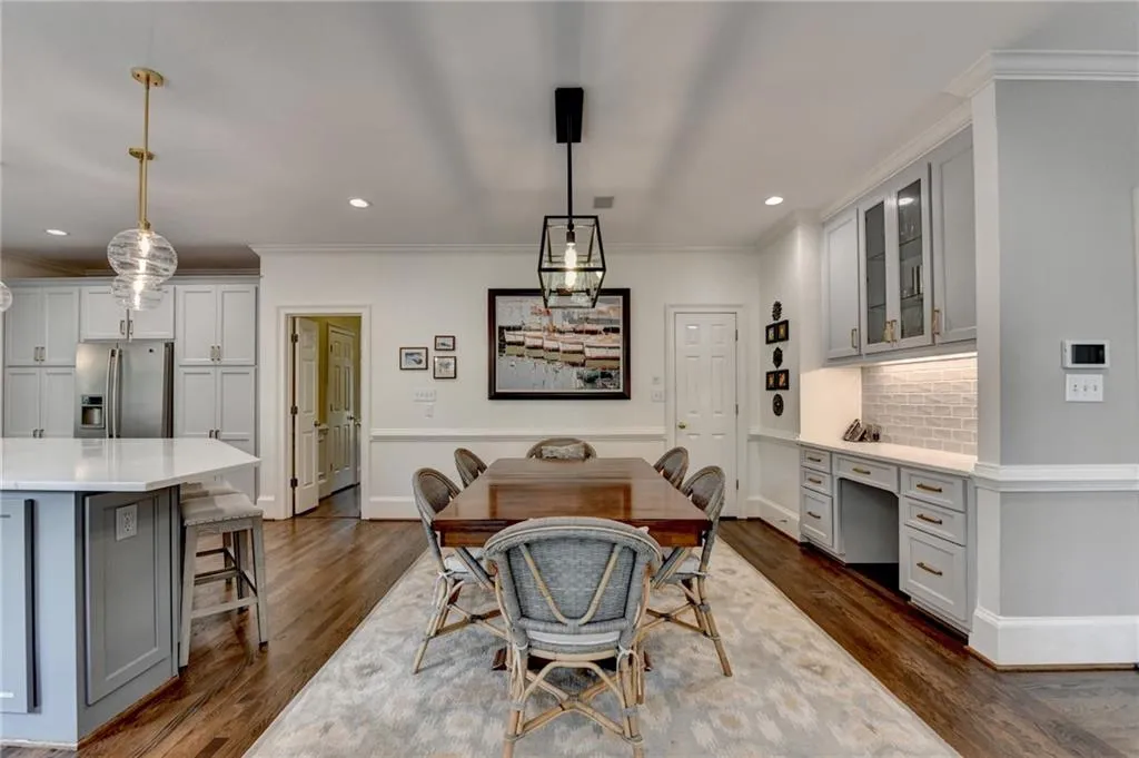 Dining room featuring built in desk, dark wood-type flooring, recessed lighting, and crown molding