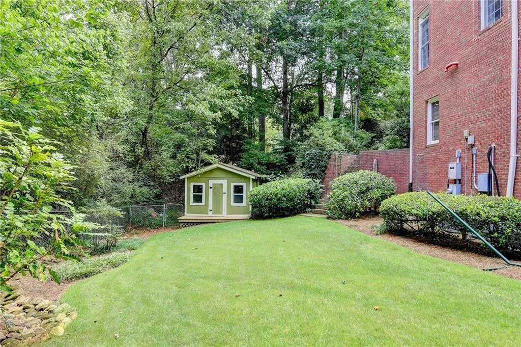 View of yard featuring a shed and a wooden deck