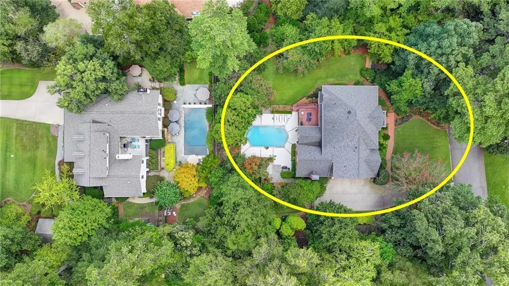 Aerial view of property and surrounding area with a pool
