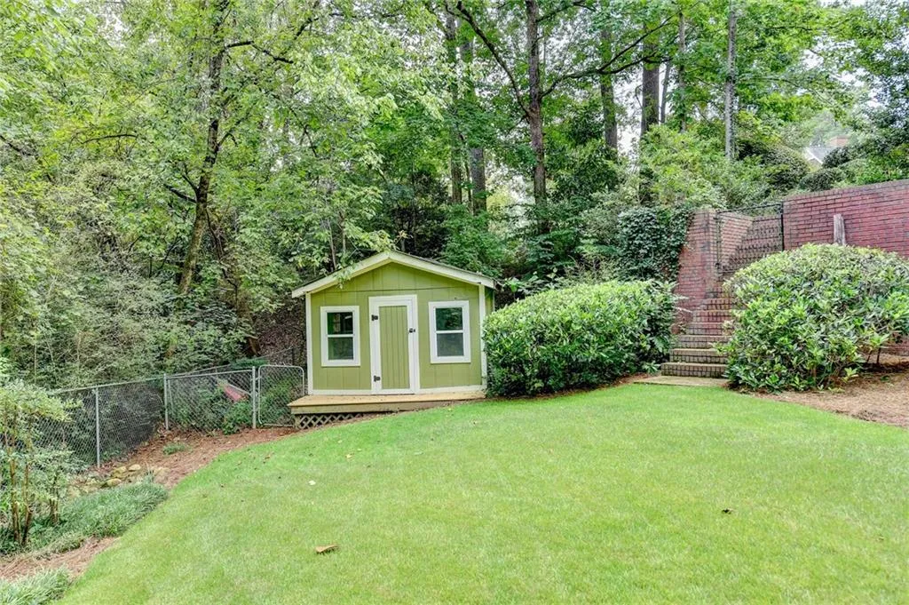 Fenced backyard with a shed and a deck