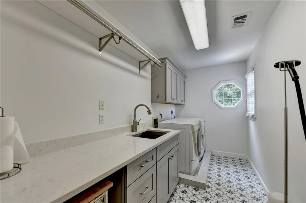 Laundry room featuring washing machine and clothes dryer and cabinet space