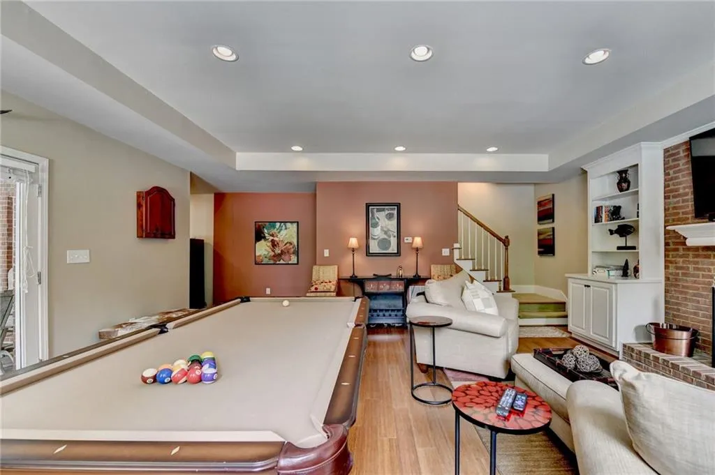 Game room featuring recessed lighting, billiards table, light wood-style floors, and a raised ceiling