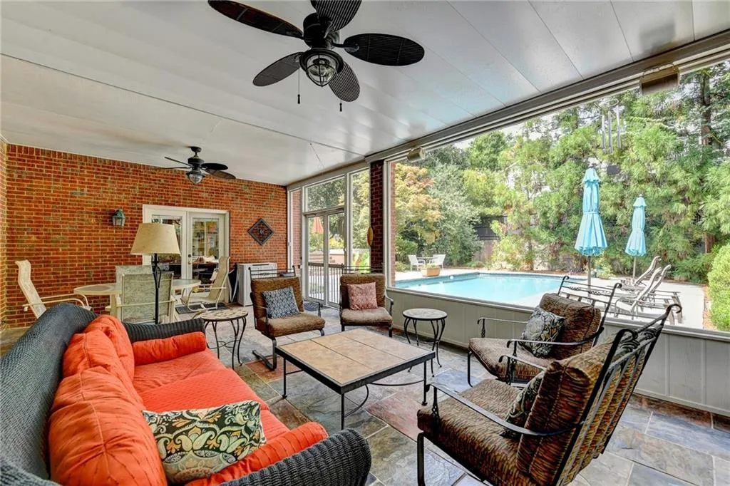 View of patio / terrace featuring an outdoor hangout area, outdoor dining space, view of scattered trees, and an outdoor pool