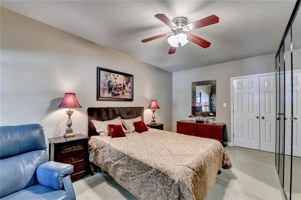 Bedroom featuring light carpet and ceiling fan