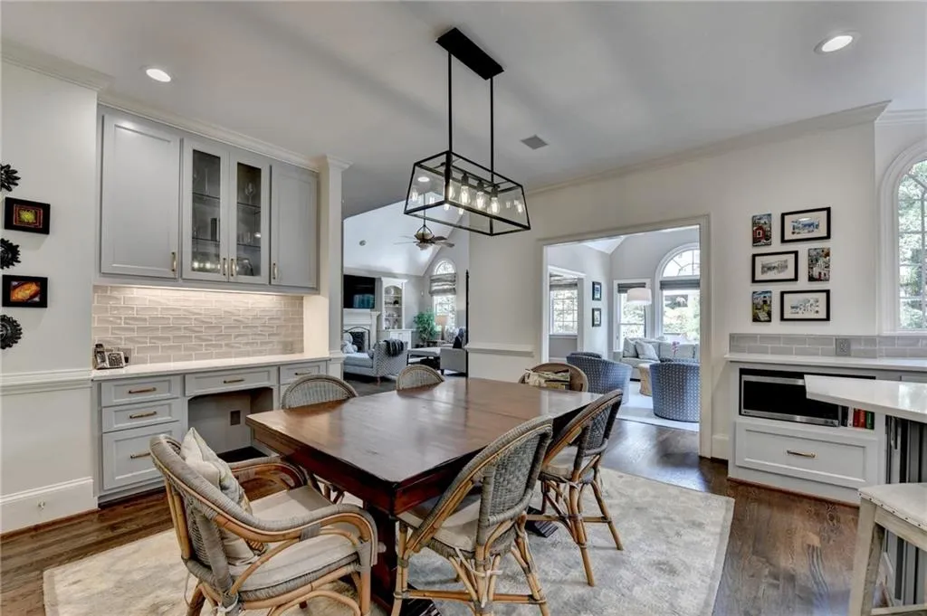 Dining room featuring recessed lighting, crown molding, dark wood-style floors, ceiling fan, and a fireplace