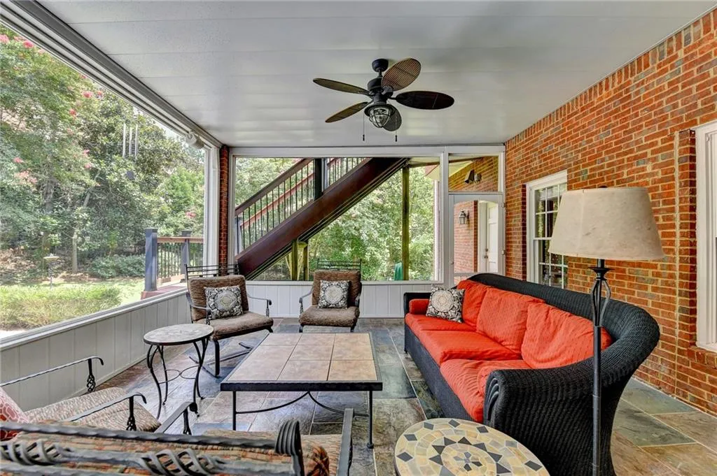 Sunroom with an outdoor living space and a ceiling fan