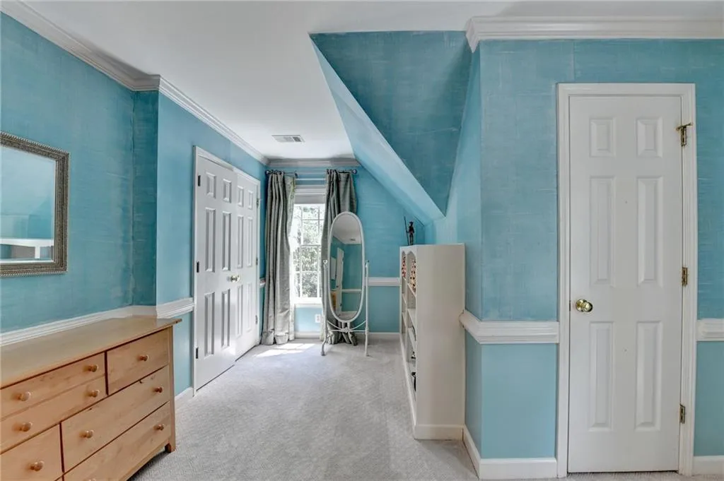 Bedroom with ornamental molding, carpet floors, and a closet