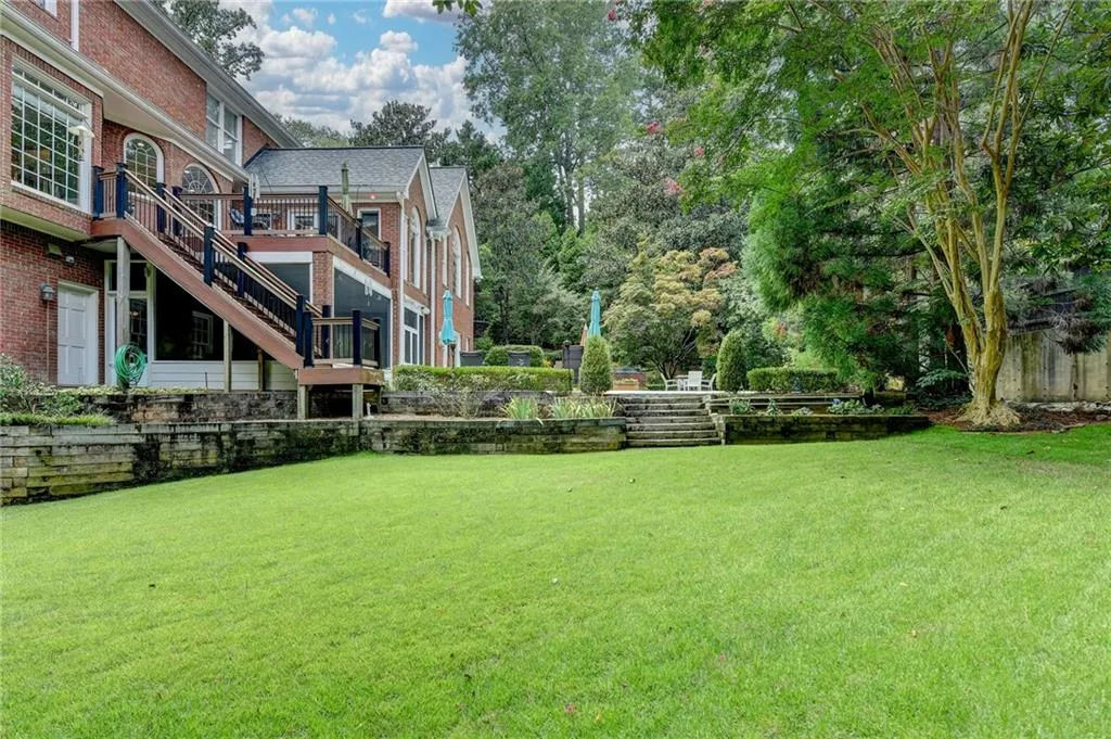 View of grassy yard featuring stairs
