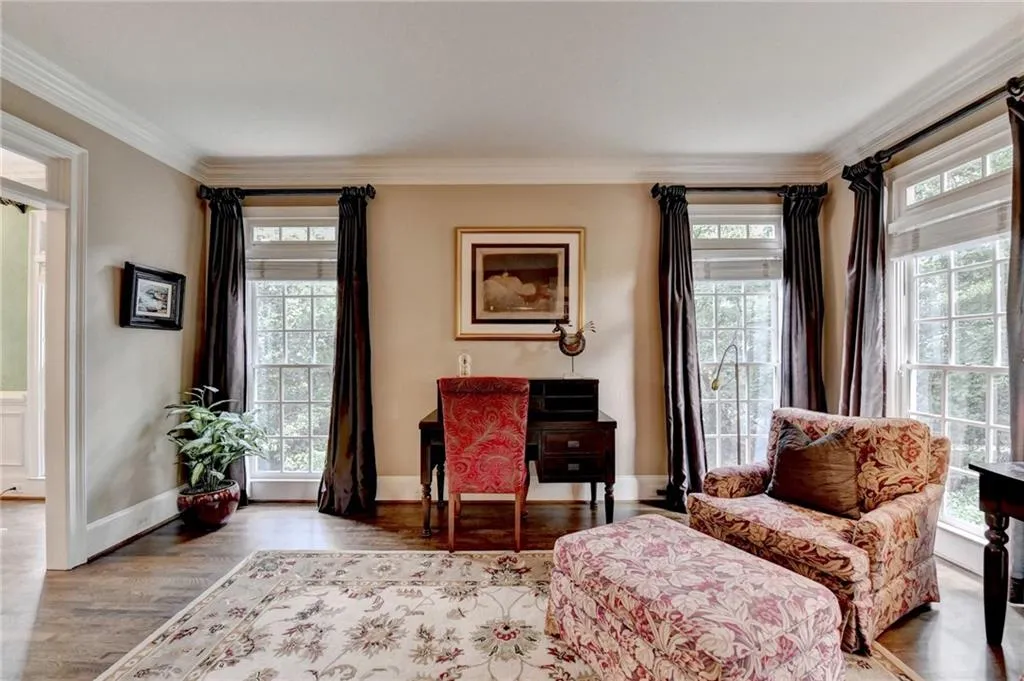 Living area featuring crown molding, wood finished floors, and an office area