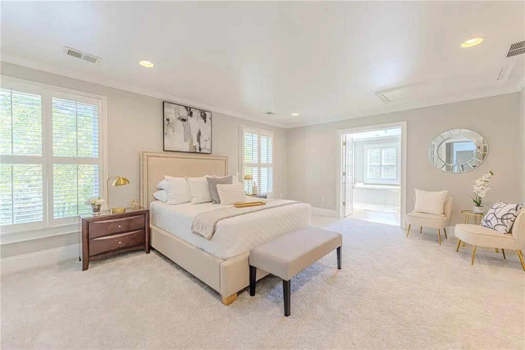 Master Bedroom with attic access, recessed lighting, light carpet, and crown molding