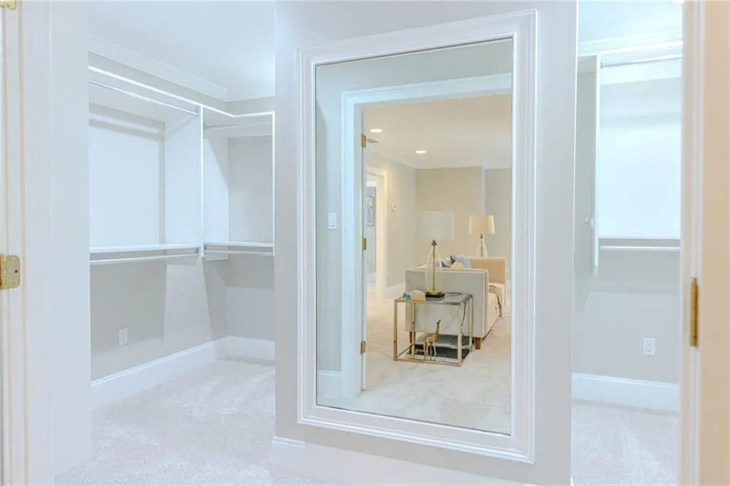 Walk in closet featuring light carpet