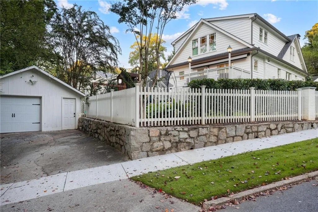 View of front of home featuring a fenced front yard, an outbuilding, and a detached garage
