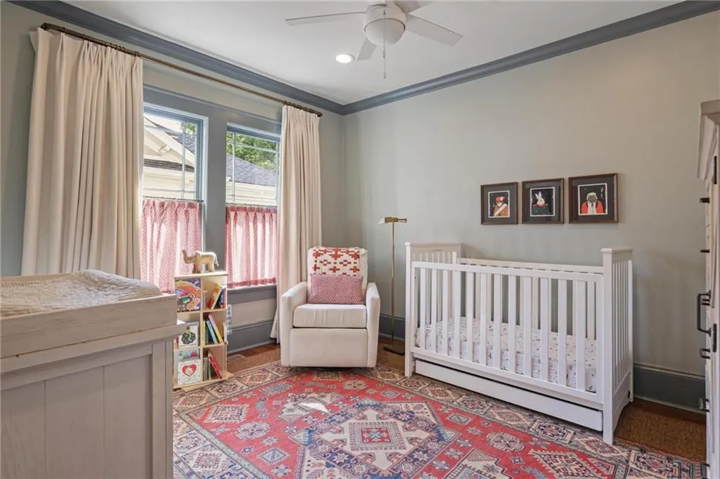 Bedroom with a nursery area, crown molding, a ceiling fan, and recessed lighting