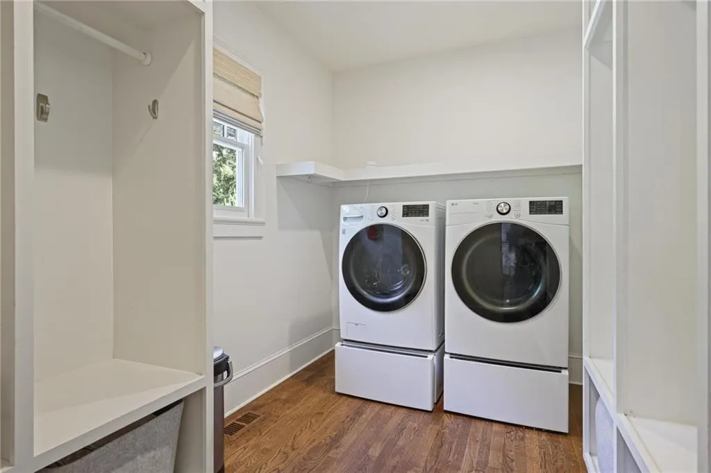 Washroom featuring dark wood finished floors and independent washer and dryer