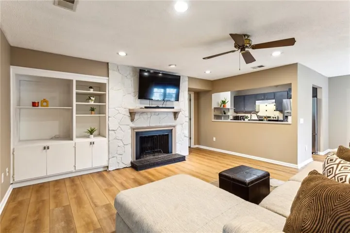 Generously-sized living room features built-ins and gorgeous painted stone fireplace.
