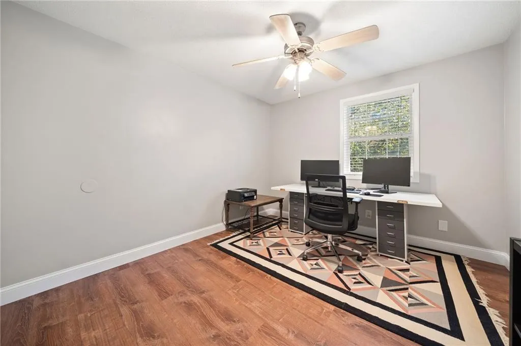 Office with ceiling fan and light hardwood / wood-style floors
