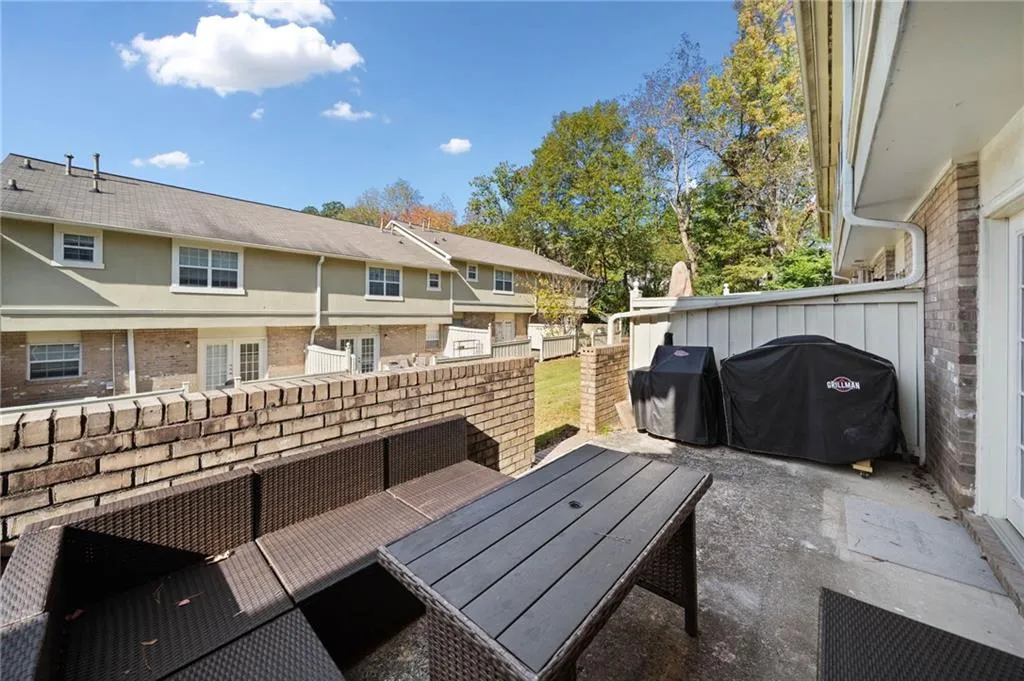 View of patio with an outdoor hangout area and grilling area
