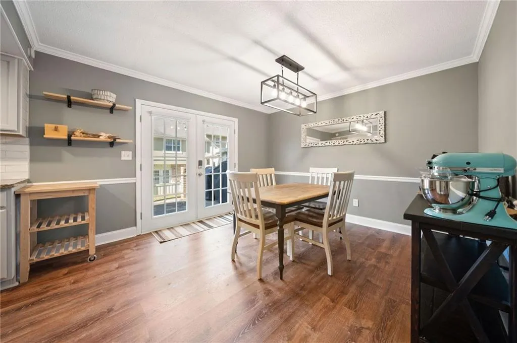 Dining area featuring dark hardwood / wood-style flooring, crown molding, and french doors