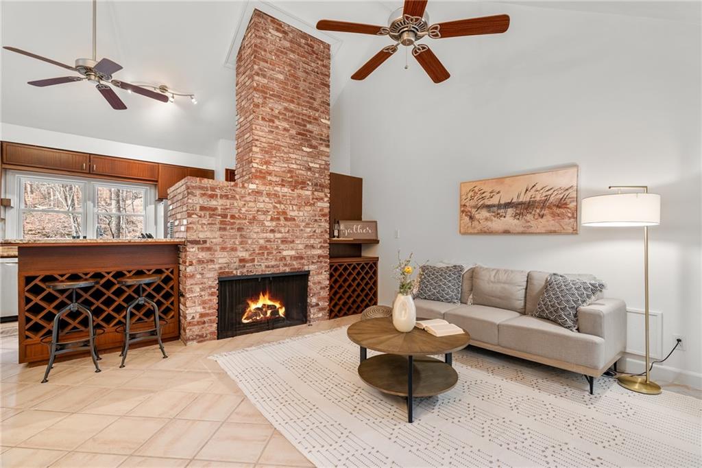 Fireside keeping room featuring brick fireplace, and high vaulted ceilings,