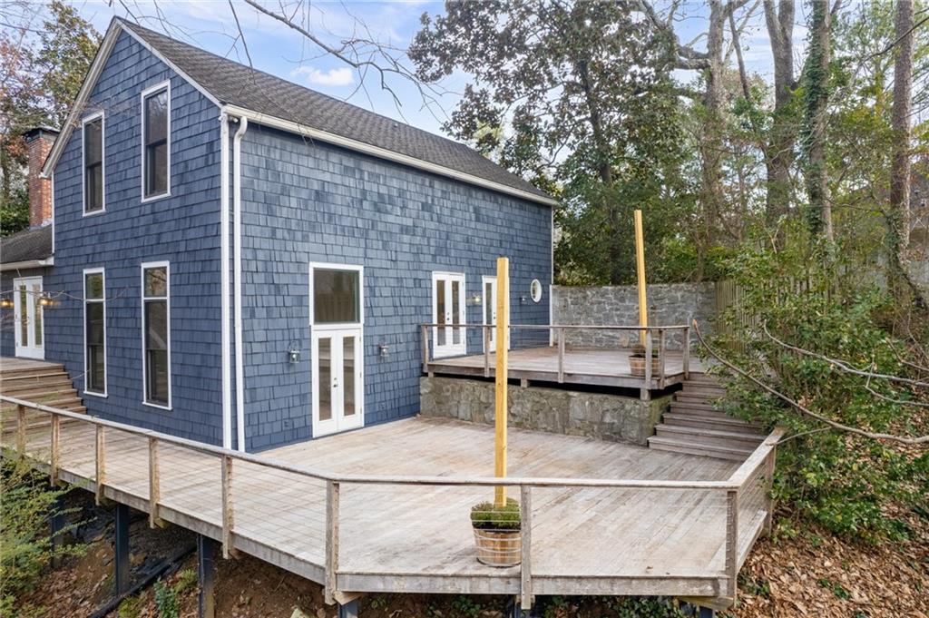 Rear view of house featuring deck systemk