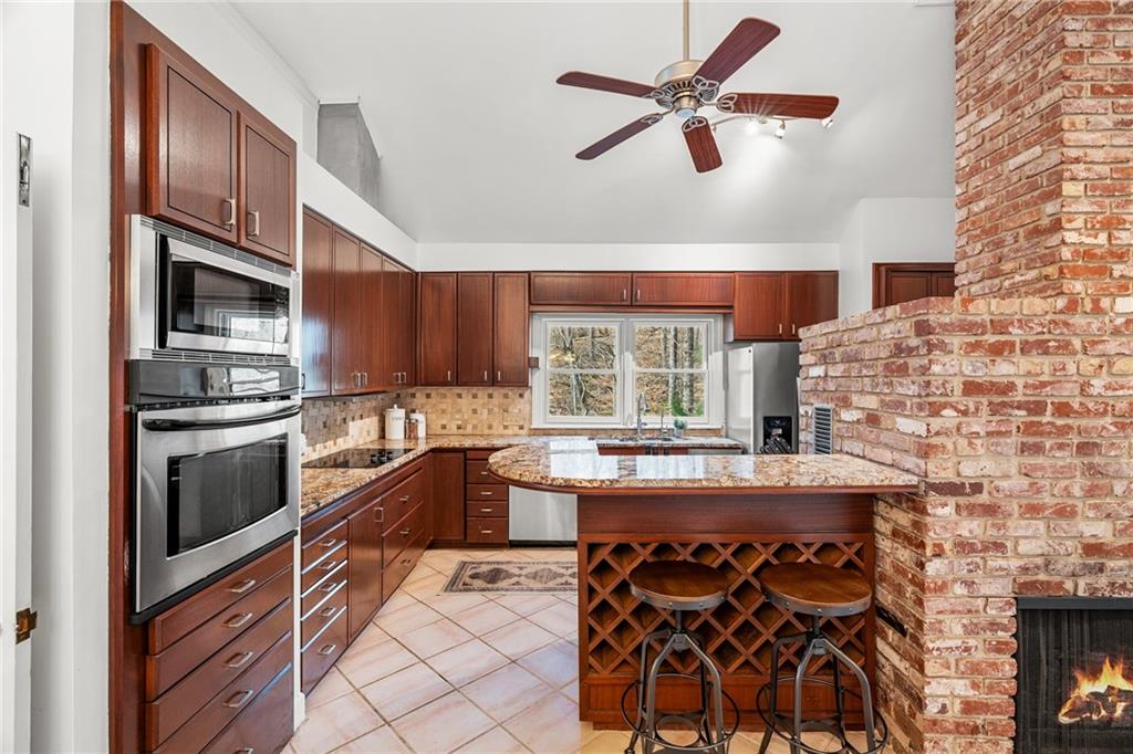 Kitchen featuring stainless steel appliances, granite countertops, and breakfast bar.