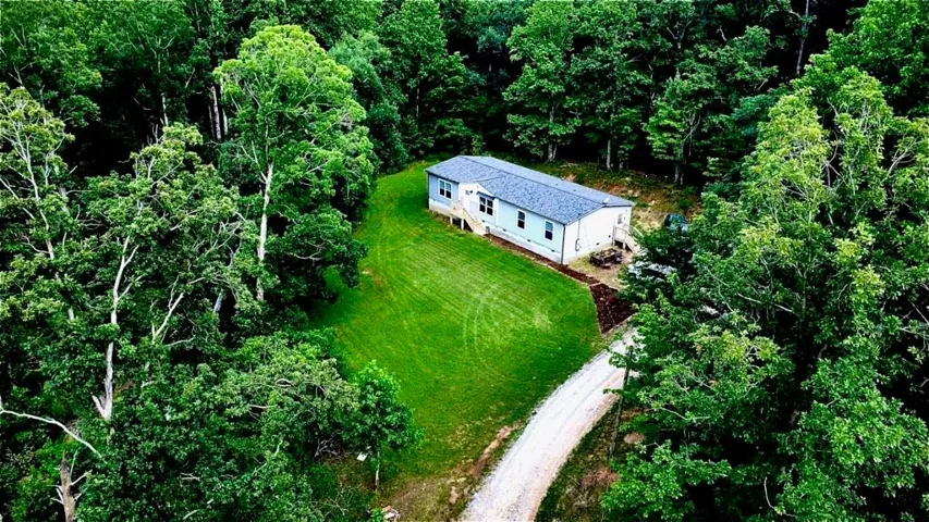 Single-story residence set amidst dense mature trees