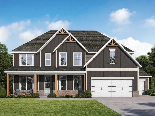 Two-story residence featuring a dark siding exterior, brick accents, a covered front porch with wood columns, a prominent two-car garage, and a gabled roofline with decorative wood trusses