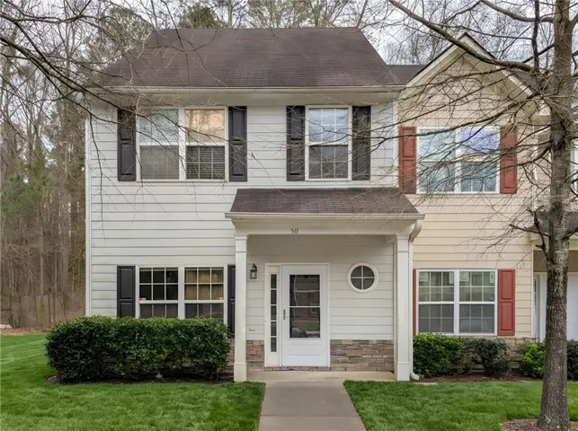 Two-story exterior with siding, a covered entry, and decorative shutters