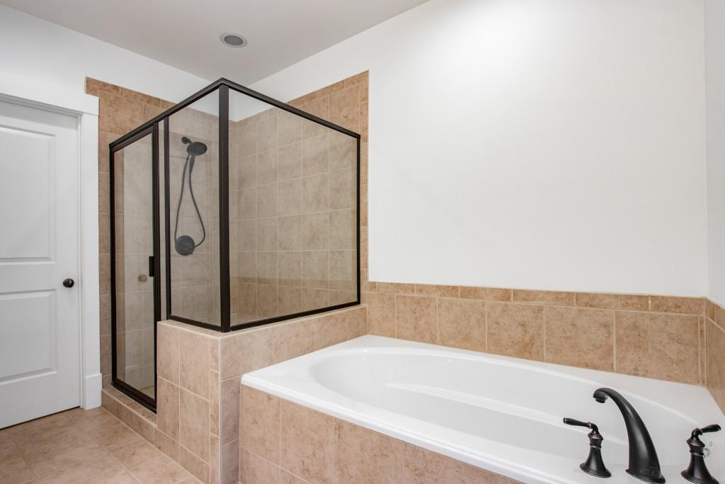 It also boasts a large soaking tub, as well as a separate glass door shower.