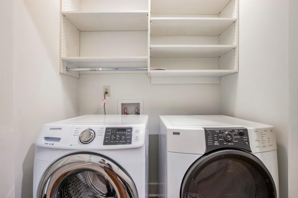 Laundry with ample shelving.