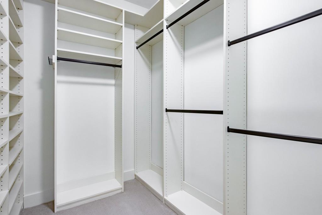 Large walk-in closet with custom storage system.