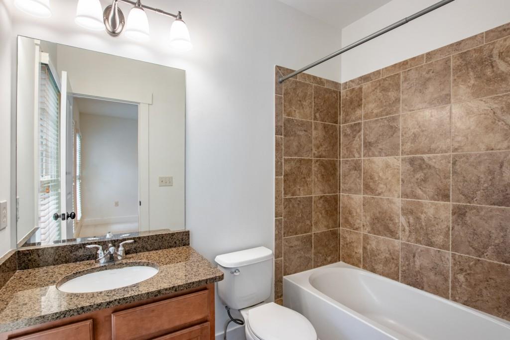 Full bath off first guest bedroom with tub/shower combo.