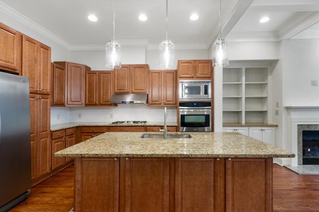 With stainless steel refrigerator, double ovens, microwave, dishwasher, and gas cooktop, this wide open kitchen is primed for you to whip up a feast!