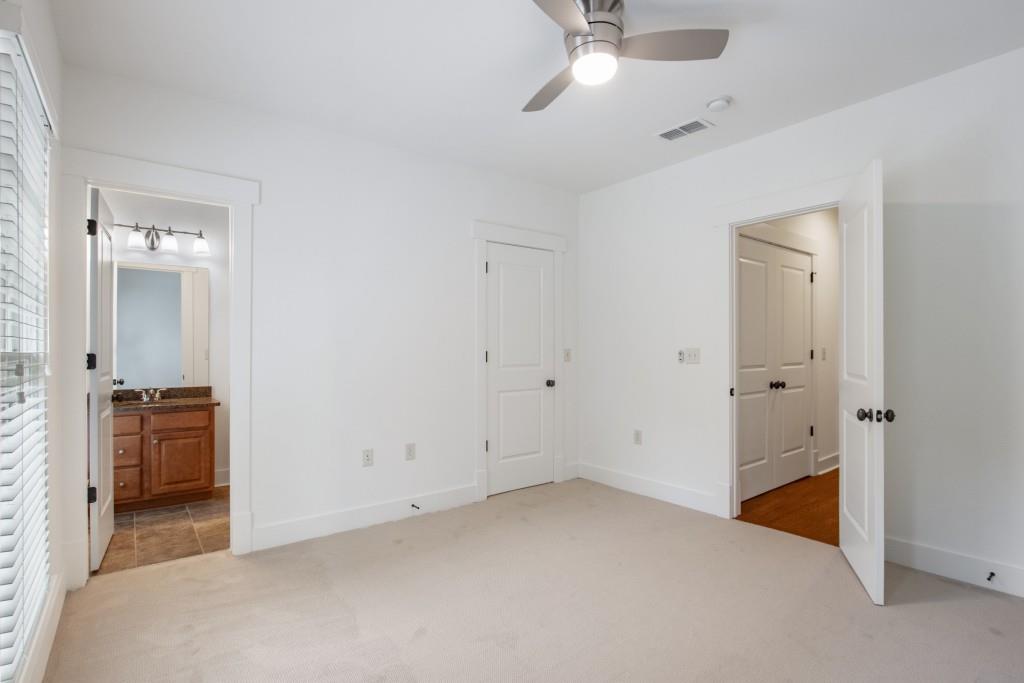 The first of three guest bedrooms is also upstairs and features a full bath.