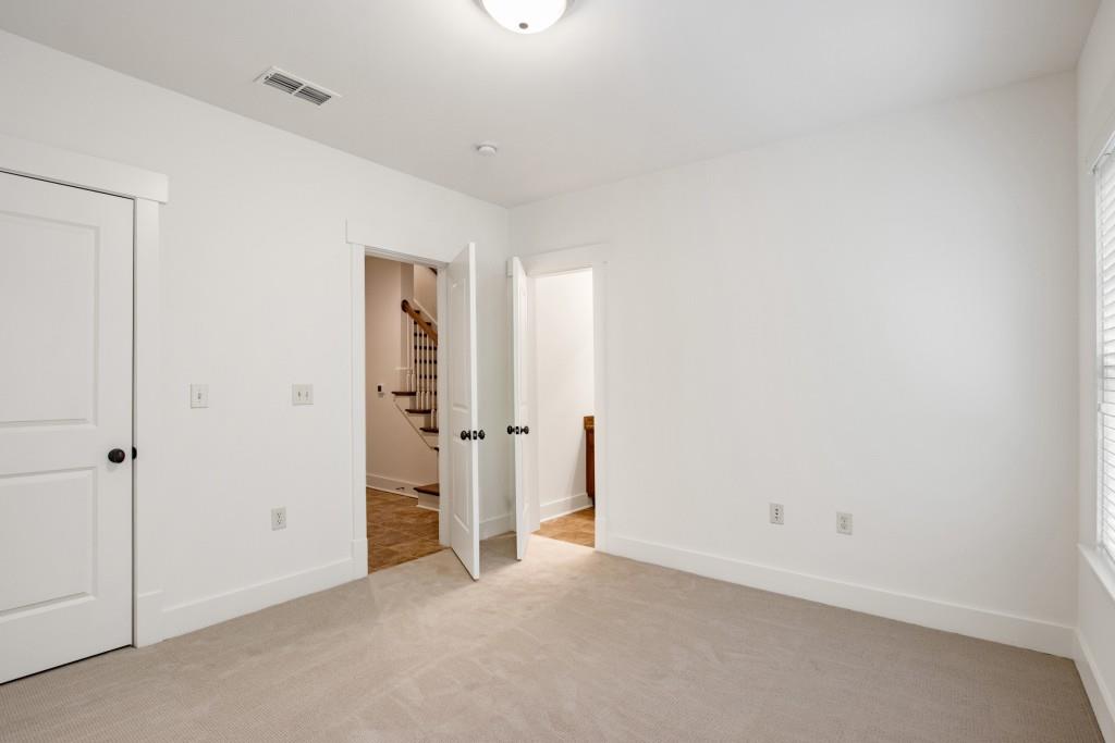 The terrace level features the third guest bedroom, also with attached full bathroom.