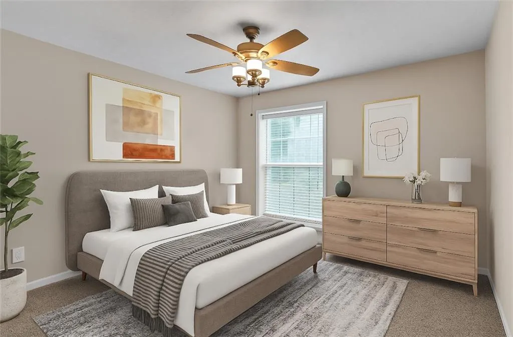 Bedroom featuring a ceiling fan and carpet floors