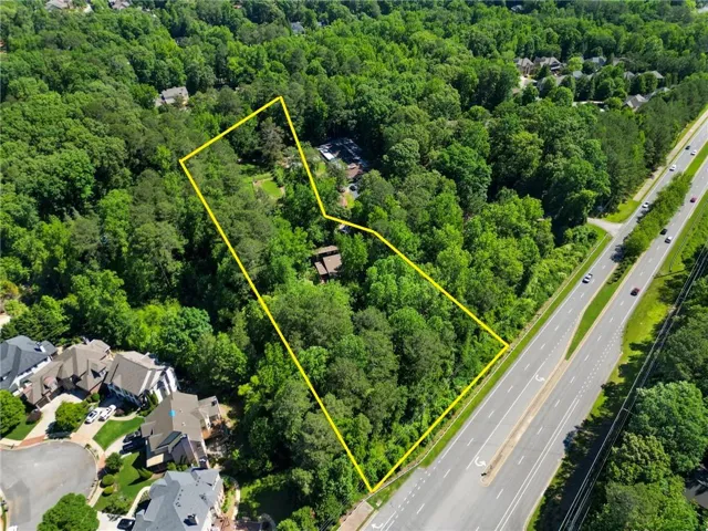Aerial view of +/- 3.7 acre property with approximate property boundaries highlighted