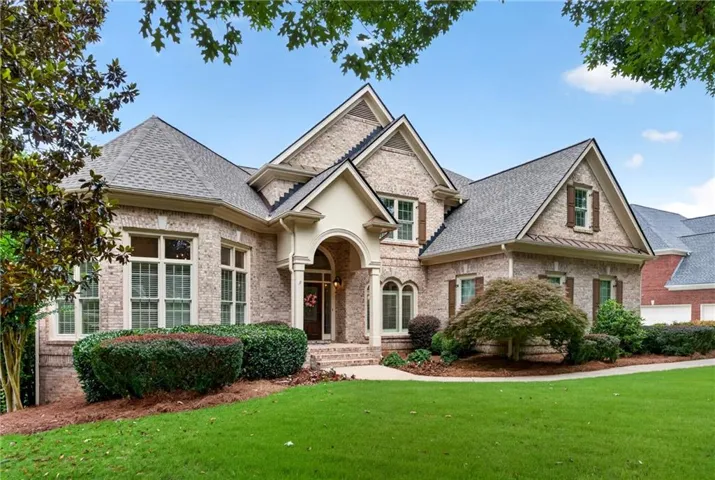 4-sided brick custom home with a side-entry garage and a level driveway.