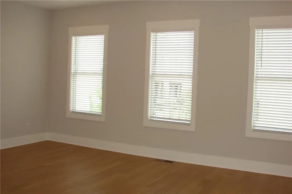 Spacious living area featuring lightwood finished floors.