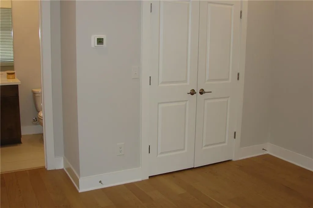 Lower-level 3rd bedroom/office closet with a view to the bathroom.