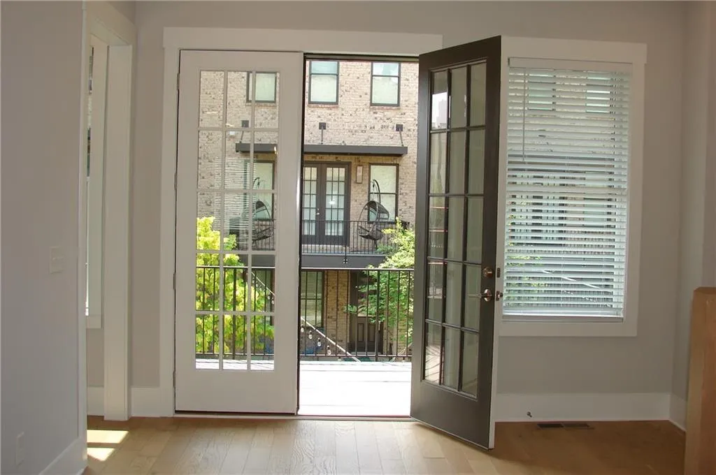 French Doors out to the deck with view of the beautiful courtyard.
