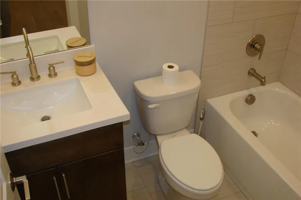 Lower-level 3rd Bathroom with vanity and tub / shower combination