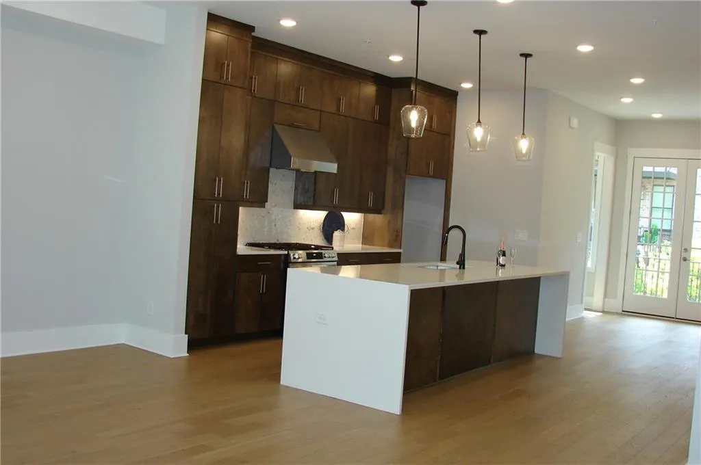 View for living area back through the kitchen and dining area