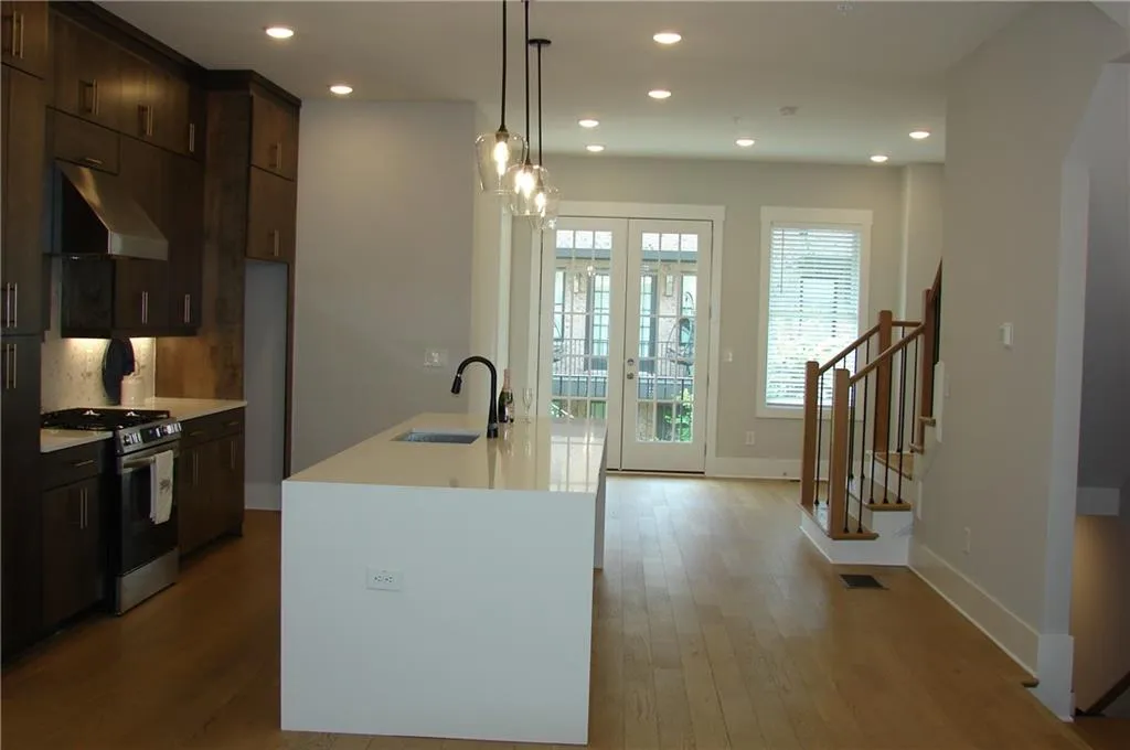 kitchen with a view through the dining area and french doors out to the deck