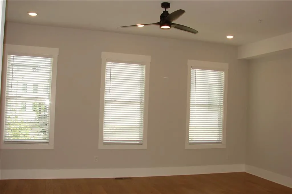 Wall of windows in living area with tons of natural light along with recessed lighting, a ceiling fan.