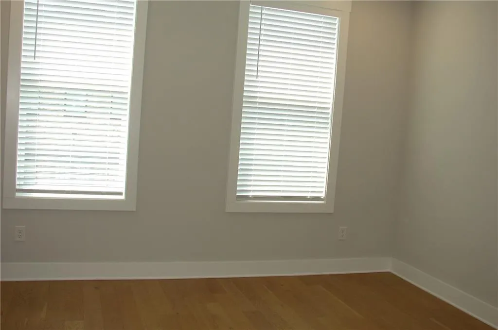 Primary bedroom featuring wood finished floors.