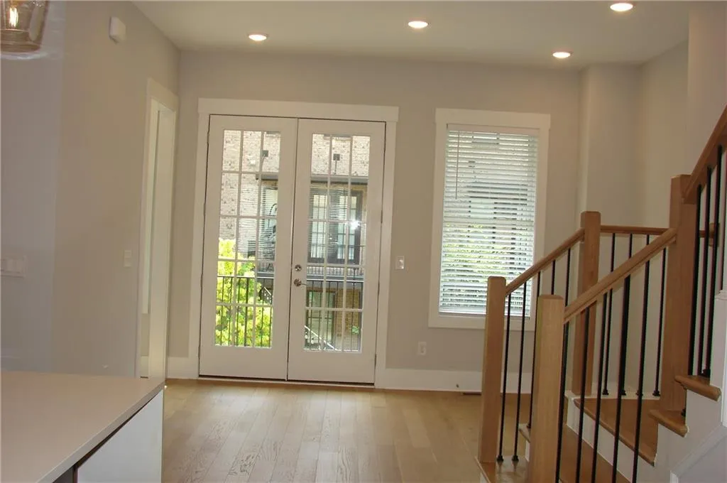 Doorway to outside with french doors, hardwood / wood-style flooring, and recessed lighting